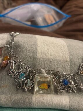 Silver-Tone Ocean Charm Bracelet featuring a fish in a bag center
